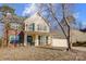 Two-story house with a brick and vinyl exterior, a covered porch, and a two-car garage at 502 Long Creek Pkwy, Charlotte, NC 28214