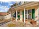 Inviting front porch with green shutters and hanging plants at 502 Long Creek Pkwy, Charlotte, NC 28214