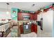 Kitchen with dark wood cabinets, granite countertops, and stainless steel appliances at 502 Long Creek Pkwy, Charlotte, NC 28214