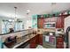 Well-equipped kitchen featuring dark wood cabinets, granite countertops, and stainless steel appliances at 502 Long Creek Pkwy, Charlotte, NC 28214