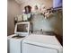 Bright laundry room, washer, dryer, and shelving at 502 Long Creek Pkwy, Charlotte, NC 28214