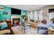 Living room with light beige couch, fireplace, and lots of natural light at 502 Long Creek Pkwy, Charlotte, NC 28214