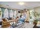 Living room with beige couch, large windows, and adjacent dining area at 502 Long Creek Pkwy, Charlotte, NC 28214