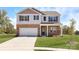 Two-story brick home with a front-facing garage and landscaped lawn at 552 Zermatt Ct, Monroe, NC 28112