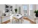 Bright dining area with white table, hardwood floors, and bay windows offering natural light at 5774 Crown Ter, Hickory, NC 28601