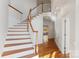 Elegant staircase with wooden railings and hardwood floors at 5774 Crown Ter, Hickory, NC 28601