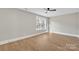 Well-lit bedroom featuring hardwood floors and a large window at 591 Shiloh Rd, Statesville, NC 28677