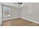 Bright bedroom with wood floors, ceiling fan, and window offering natural light at 591 Shiloh Rd, Statesville, NC 28677