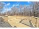 Wooden deck overlooking a backyard with trees and grass at 591 Shiloh Rd, Statesville, NC 28677