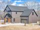 Modern farmhouse style home with gray siding and a metal roof at 591 Shiloh Rd, Statesville, NC 28677