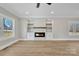 Living room fireplace with whitewashed brick and wood mantel at 591 Shiloh Rd, Statesville, NC 28677