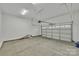 Spacious garage with overhead door and concrete floor at 591 Shiloh Rd, Statesville, NC 28677