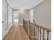 Hardwood floor hallway with staircase and white doors at 591 Shiloh Rd, Statesville, NC 28677