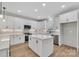 Modern kitchen with island, white cabinets, and quartz countertops at 591 Shiloh Rd, Statesville, NC 28677