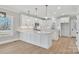 Modern kitchen with white cabinets, quartz countertops and stainless steel appliances at 591 Shiloh Rd, Statesville, NC 28677