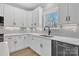 Modern kitchen with white cabinets, quartz countertops, and black faucet at 591 Shiloh Rd, Statesville, NC 28677