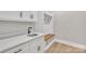 Laundry room with white cabinets, quartz countertops, and wooden bench at 591 Shiloh Rd, Statesville, NC 28677