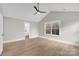 Main bedroom with hardwood floors, large window, and ensuite bath at 591 Shiloh Rd, Statesville, NC 28677