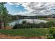 Scenic community lake with walking path and houses in background at 6014 Cadence Ln, Fort Mill, SC 29707