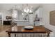 Dining room with wooden table and chandelier, open to kitchen at 6014 Cadence Ln, Fort Mill, SC 29707