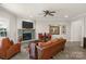 Living room with stone fireplace, hardwood floors, and seating at 6014 Cadence Ln, Fort Mill, SC 29707