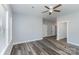 Bright bedroom with ceiling fan and wood-look floors at 619 Norland Ave, Kannapolis, NC 28083