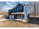 Two-story house with dark blue siding, white garage door, and a stone accent at 619 Norland Ave, Kannapolis, NC 28083