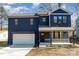 Two-story house with dark blue siding, white garage door, and a stone accent at 619 Norland Ave, Kannapolis, NC 28083