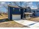 Two-story house with dark blue siding, white garage door, and a stone accent at 619 Norland Ave, Kannapolis, NC 28083