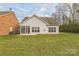 The back exterior of a single-Gathering home with a grass lawn, patio, and sunroom at 629 Cordova Ct, Salisbury, NC 28146
