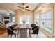 Bright dining area with a modern table, seating for eight, and a view to the backyard at 629 Cordova Ct, Salisbury, NC 28146