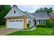 Charming one-story home featuring a stone and siding facade, attached garage, and beautifully landscaped front yard at 629 Cordova Ct, Salisbury, NC 28146