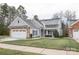 Charming one-story home with gray siding, stone accents, and a two-car garage at 629 Cordova Ct, Salisbury, NC 28146