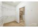Spacious walk-in closet with custom shelving, leading to bathroom with glass shower door at 629 Cordova Ct, Salisbury, NC 28146