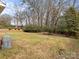 Large backyard with trees and grass at 6439 Montpelier Rd, Charlotte, NC 28210