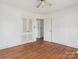 Simple bedroom with hardwood floors and double door closet at 6439 Montpelier Rd, Charlotte, NC 28210