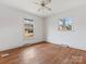 Bedroom featuring hardwood floors and two windows at 6439 Montpelier Rd, Charlotte, NC 28210