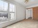 Bedroom with brick accent wall and large window at 6439 Montpelier Rd, Charlotte, NC 28210