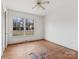 Bright bedroom with hardwood floors and large window at 6439 Montpelier Rd, Charlotte, NC 28210