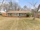 Brick ranch house with teal shutters and a spacious lawn at 6439 Montpelier Rd, Charlotte, NC 28210