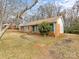 Side view of brick ranch house with teal shutters at 6439 Montpelier Rd, Charlotte, NC 28210