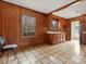 Retro kitchen with wood paneling, tiled floor, and vintage appliances at 6439 Montpelier Rd, Charlotte, NC 28210