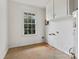 Small laundry room with overhead cabinets and window at 6439 Montpelier Rd, Charlotte, NC 28210