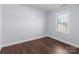 Spacious bedroom with dark wood floors and large window at 646 Central Nw Dr, Concord, NC 28027