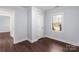 Bedroom with dark wood floors, window, and closet at 646 Central Nw Dr, Concord, NC 28027