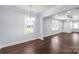 Light-filled dining area with hardwood floors and a chandelier at 646 Central Nw Dr, Concord, NC 28027