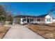 Newly renovated home with covered porch and driveway at 646 Central Nw Dr, Concord, NC 28027