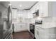 Modern kitchen with white cabinets and quartz countertops at 646 Central Nw Dr, Concord, NC 28027