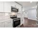 Kitchen with stainless steel appliances and white cabinets at 646 Central Nw Dr, Concord, NC 28027