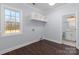 Bright laundry room with dark wood floors and built-in shelving at 646 Central Nw Dr, Concord, NC 28027